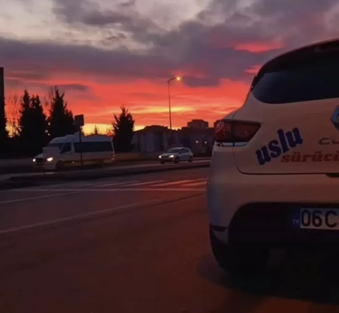 Uslu Sürücü Kursu logolu direksiyon eğitim otomobili, gün batımında